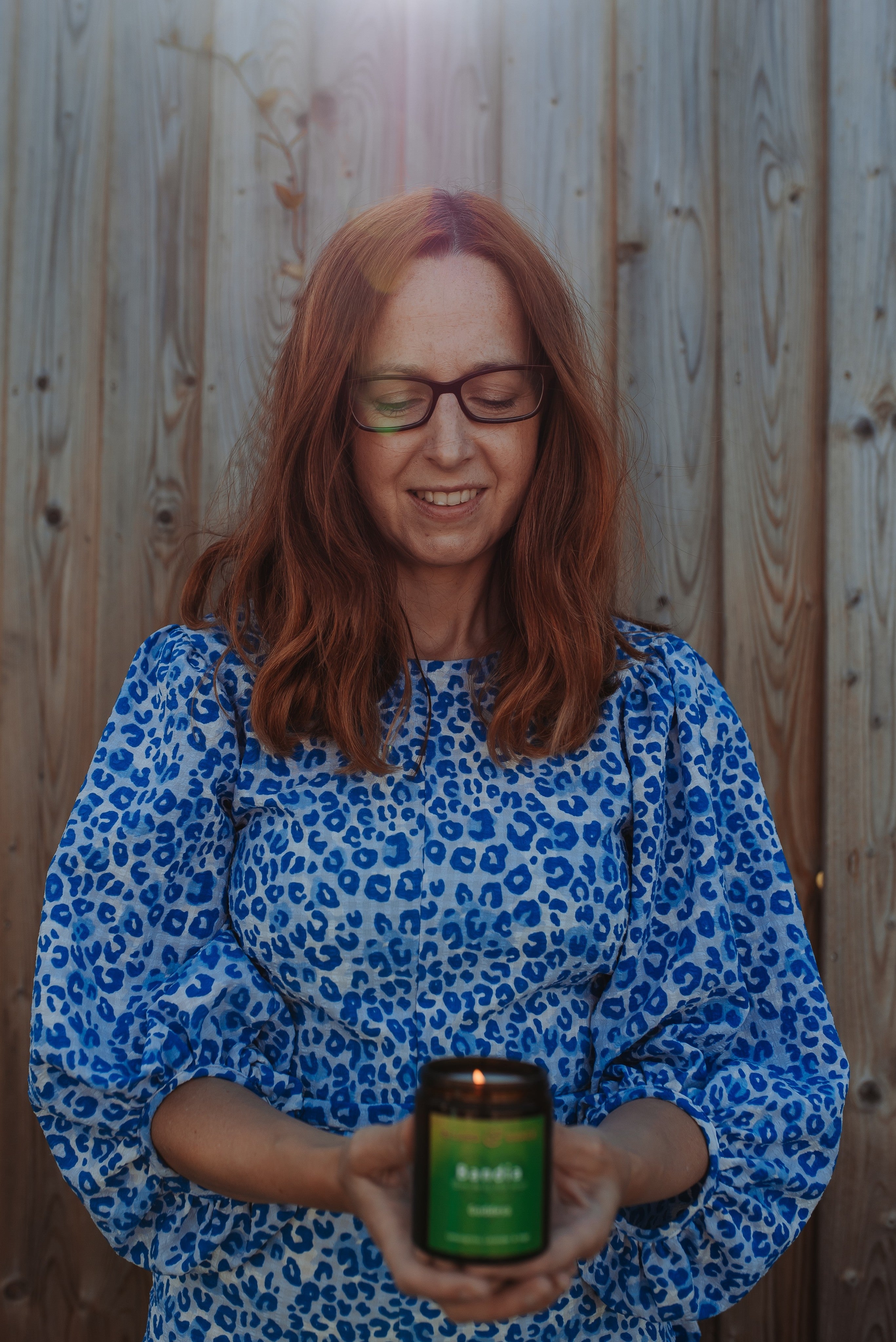 Founder of Wizard & Grace, Paula McGovern, holding one of her essential oil candles